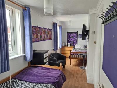 Color Purple twin - ideal for friends sharing. En-suite shower room.